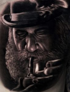 pipe smoking man with beard Irish tattoo in bushwick