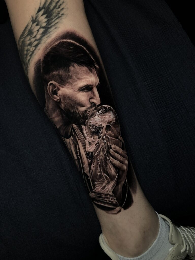Messi kissing the world cup trophy tattoo realism black and white in leg